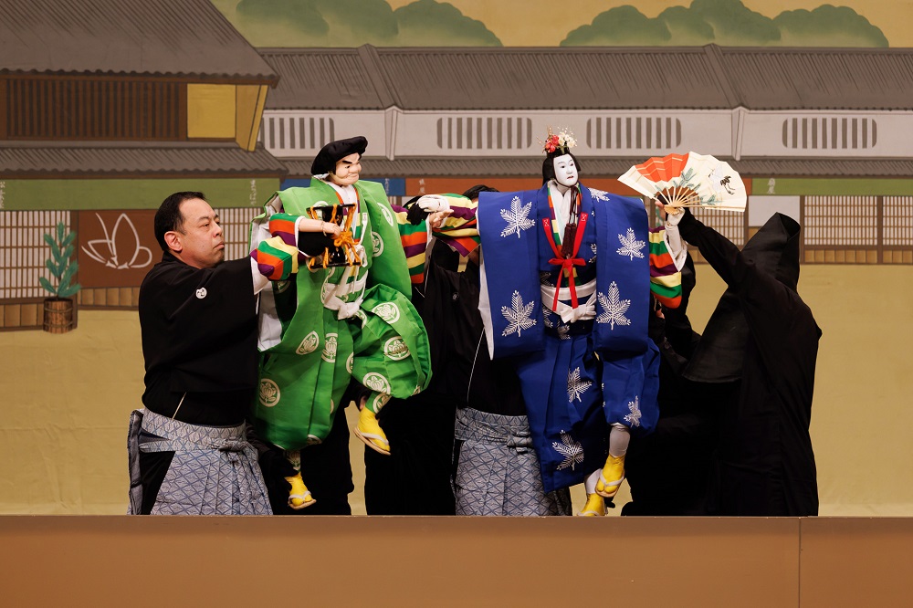 【Aプロ】京都の町並みで新春を寿ぐ才蔵（左）と太夫（右）