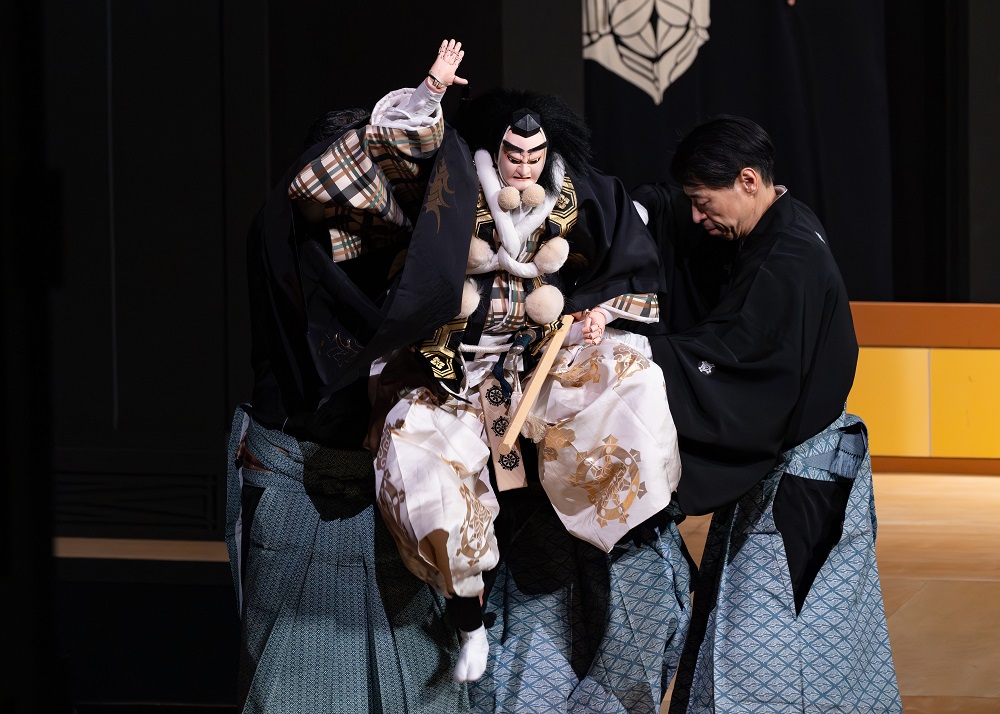 写真：花道にて、手を大きく振り勢いよく足を踏み鳴らして走っていく、飛び六方で、よしつねたちの後を追う、べんけい